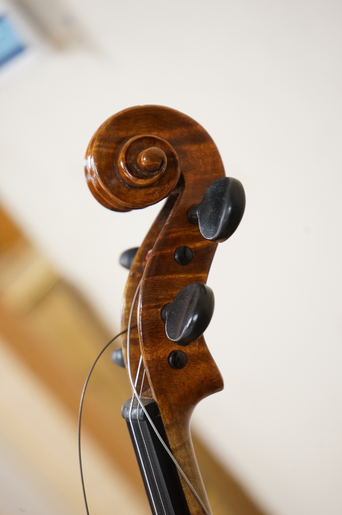 Three violins; a late 19th century German Stradivarius pattern violin, without label, a handmade violin (a.f.), with sound post crack, broken and repaired scroll, etc. and a Maidstone violin body, varnish stripped from t